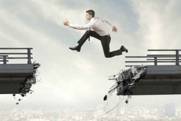 man leaping across broken section of the bridge using a Prayer To Achieve Intentions before making his leap