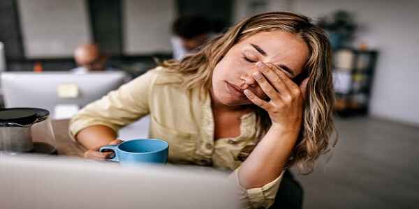 woman in front of laptop looking worn down in need of rejuvenation and a Prayer When Weary.