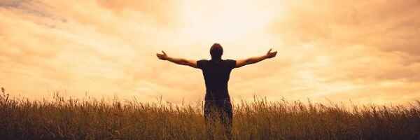 Man praying in wheat field, looking up, Prayer Guides