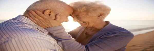 Elderly couple on beach,
 strong bond 