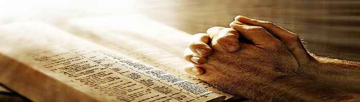 Open Bible with light, hands folded in prayer