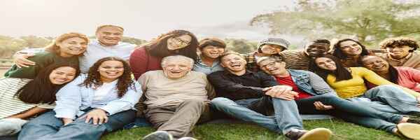 A happy multi generational family gathered together, smiling and laughing.