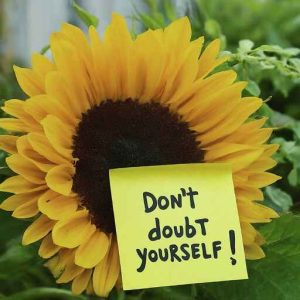 Sunflower with post-it note, don't doubt yourself, overcome self-doubt