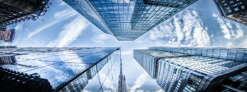 A breathtaking view looking up from a bustling city street, where towering skyscrapers frame a vast, open sky, symbolizing limitless possibilities and expanded perspective.